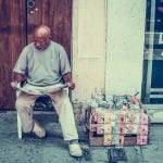 Man sitting reading newspaper - 